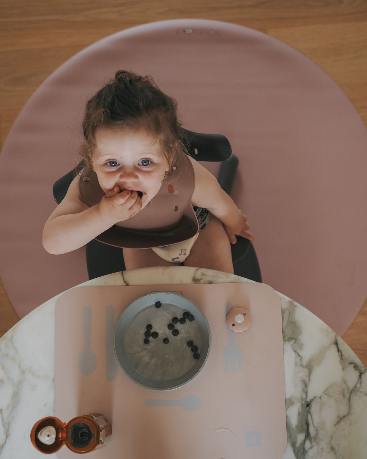Old rose round mat for placing under high chair to protect floors from food spills