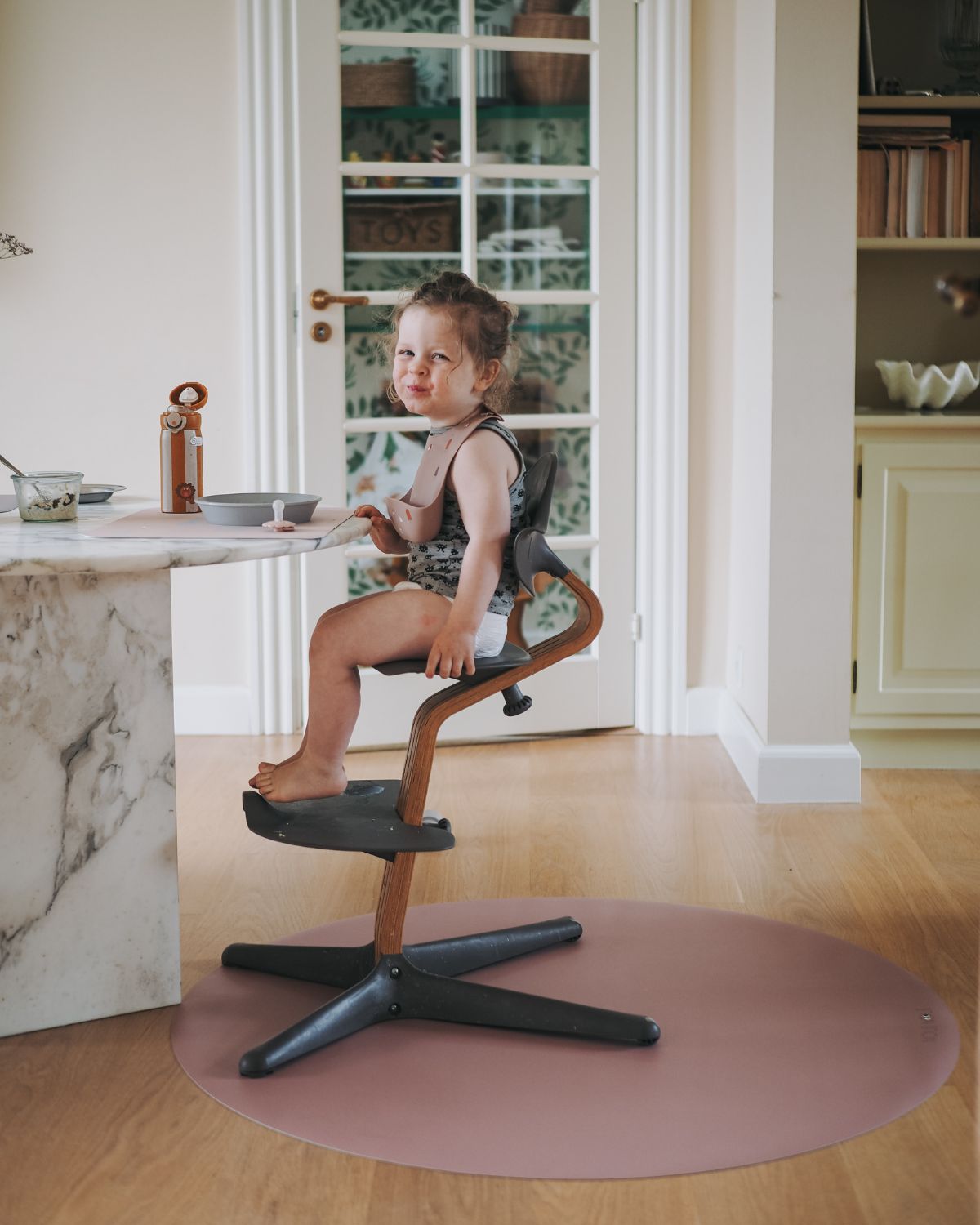 Old rose round mat for placing under high chair to protect floors from food spills