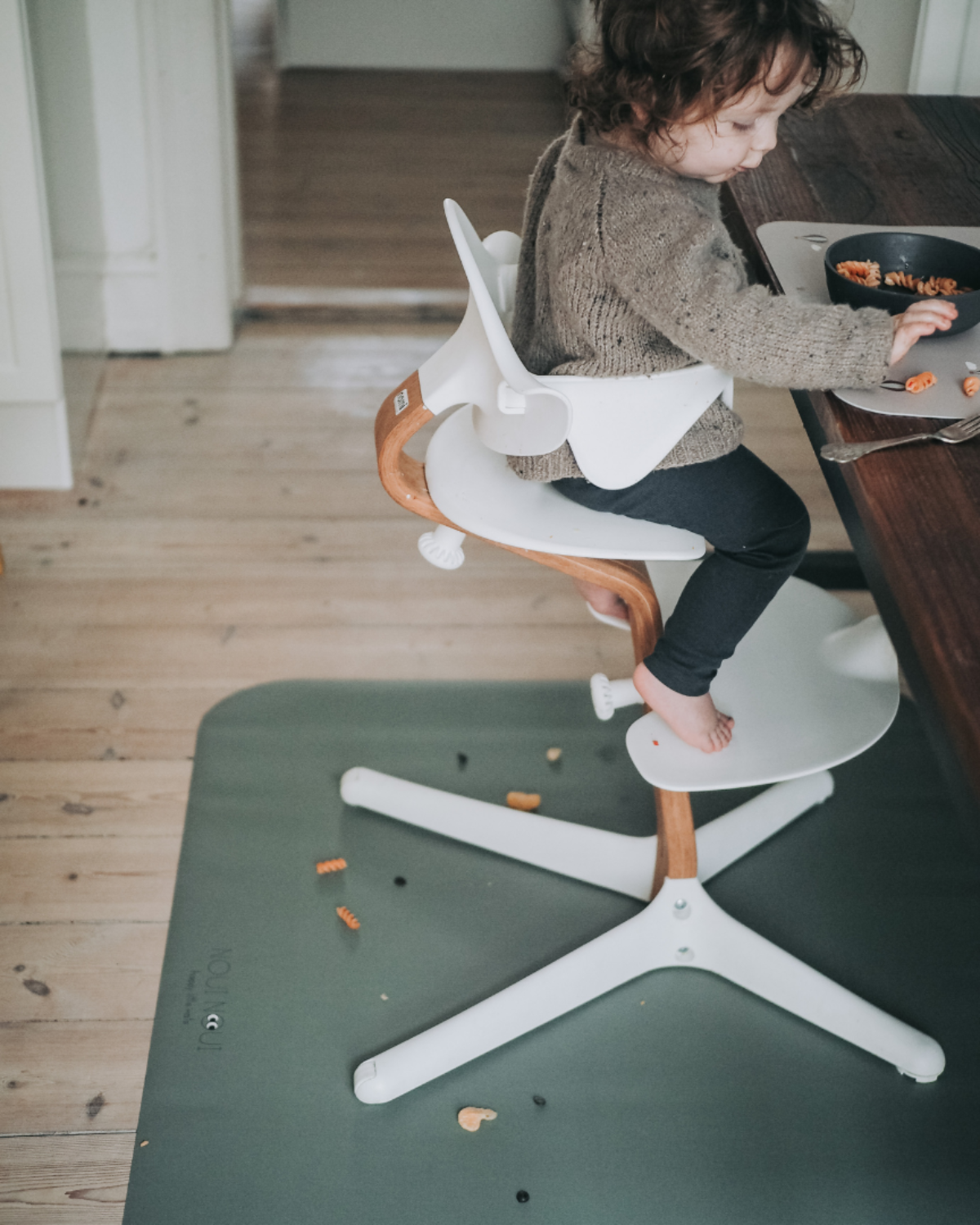 A rectangular dusty olive high chair floor mat laid out flat. Protects all kind of flooring from spills and fluids.