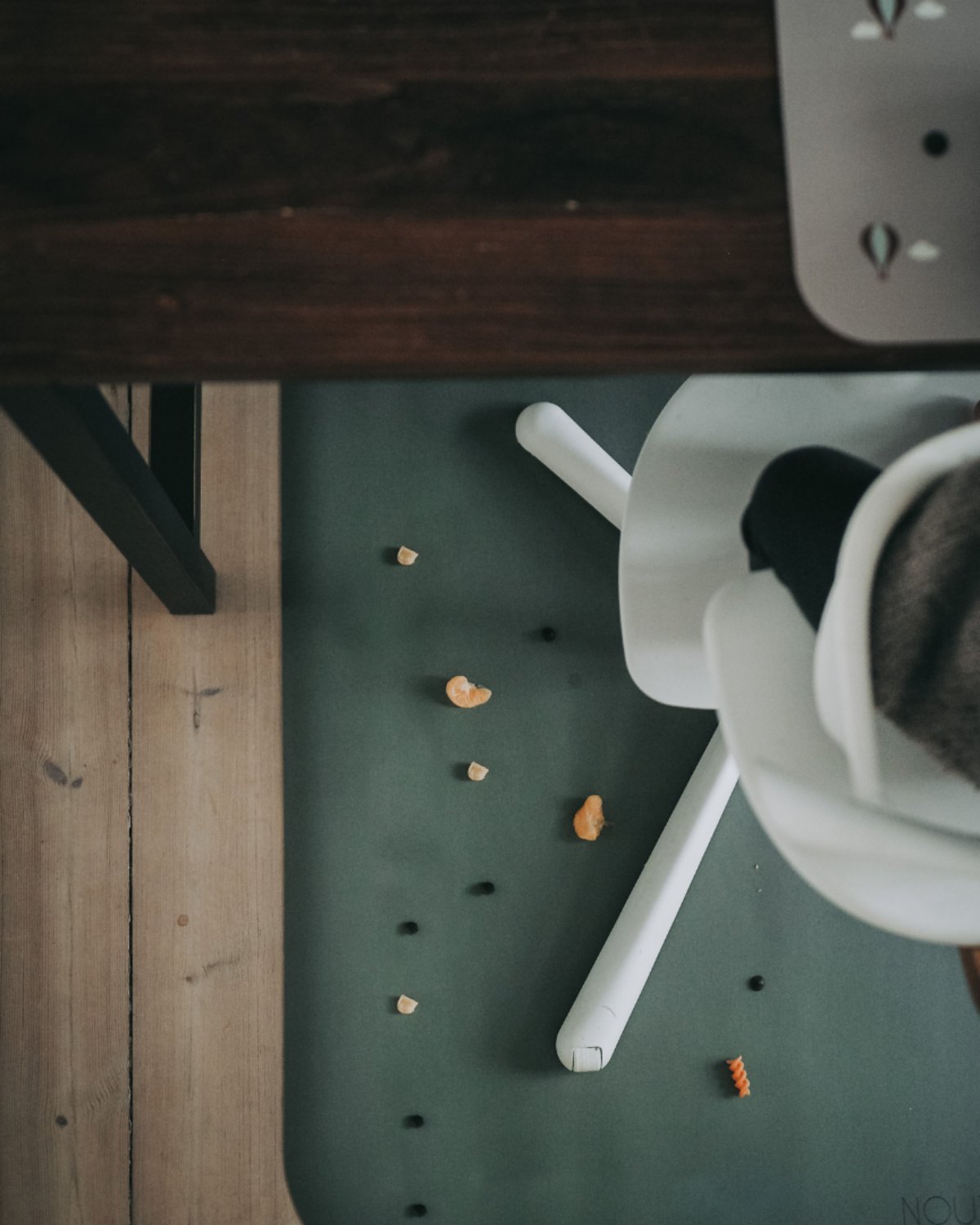 A rectangular dusty olive high chair floor mat laid out flat. Protects all kind of flooring from spills and fluids.