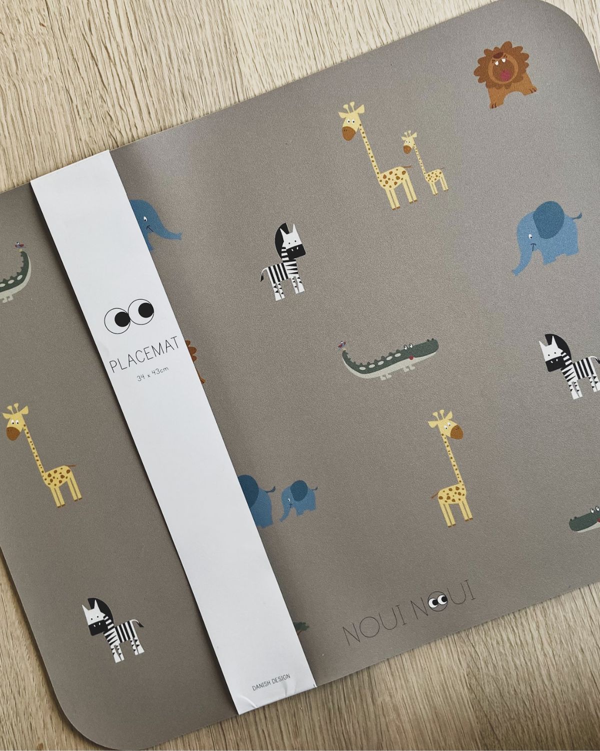 Placemat with various cute safari animals including an elephant, giraffe, and other safari animals.