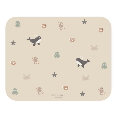 A rectangular high chair floor mat with a pattern of various ocean animals, such as whales and octopuses, on a nude background.