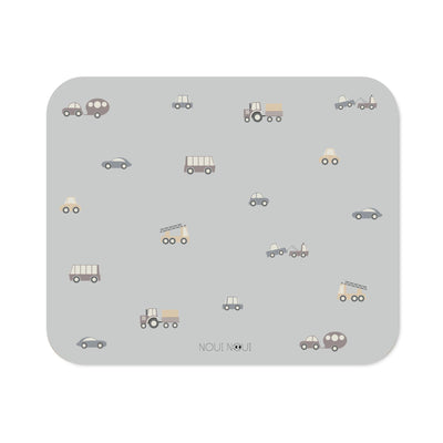 XL placemat with a gray background and a pattern of various small vehicles, including cars, trucks, and trains, across the surface.