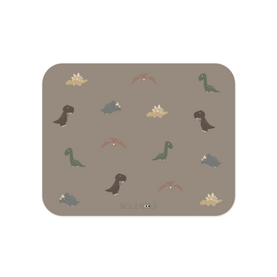 Placemat with various illustrations of dinosaurs in shades of green, brown, and gray, on a cocoa background.