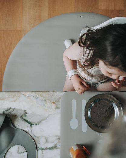 Stylish olive haze round floor mat under high chair – protects floors during baby mealtime