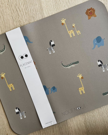 Placemat with various cute safari animals including an elephant, giraffe, and other safari animals.