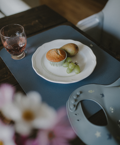 Our soft silicone bib in dusty blue color with small see animal illustrations and an adjustable neck strap. Paired with our placemat in dusty blue.
